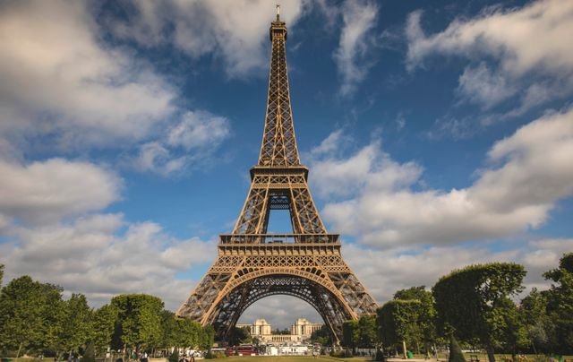 A breathtaking view of the Eiffel Tower against a blue sky in Paris, France.