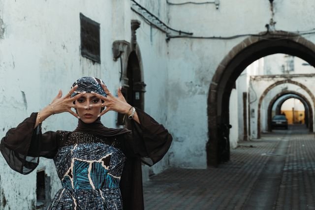 A striking portrait of a woman in traditional attire in the historic streets of Casablanca, Morocco.